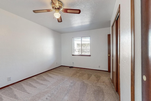 12522 Singing Arrow Ave SE, Albuquerque, NM 87123 - carpeted empty room with baseboards, a ceiling fan, and a textured ceiling