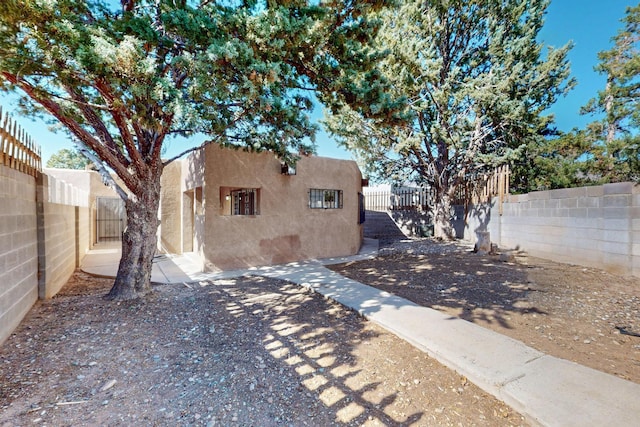 12522 Singing Arrow Ave SE, Albuquerque, NM 87123 - view of side of property with a fenced backyard and stucco siding