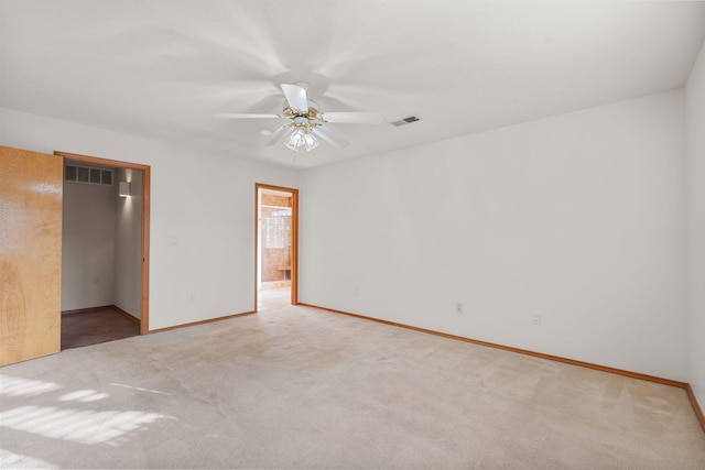 unfurnished bedroom with carpet, visible vents, a spacious closet, and baseboards