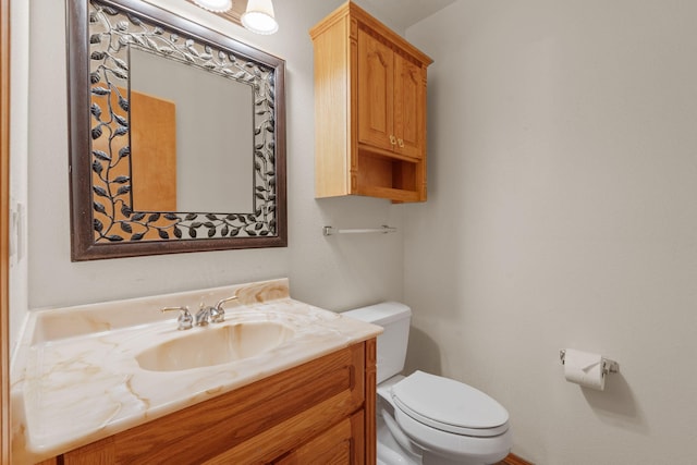 half bath featuring toilet and vanity