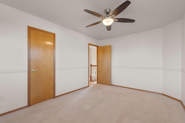 unfurnished bedroom with baseboards, ceiling fan, and carpet