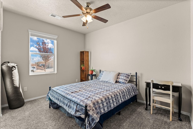 carpeted bedroom featuring a textured ceiling, ceiling fan, baseboards, and visible vents