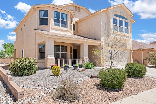 10532 Box Canyon Pl NW, Albuquerque, NM 87114 - view of front facade with stucco siding, a porch, a garage, and fence