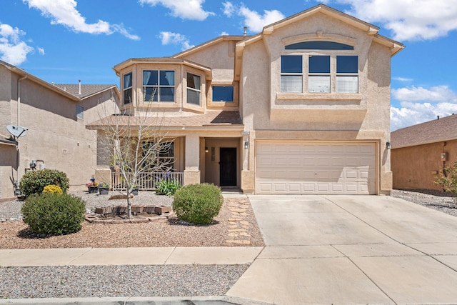10532 Box Canyon Pl NW, Albuquerque, NM 87114 - view of front facade with stucco siding, a porch, an attached garage, and concrete driveway