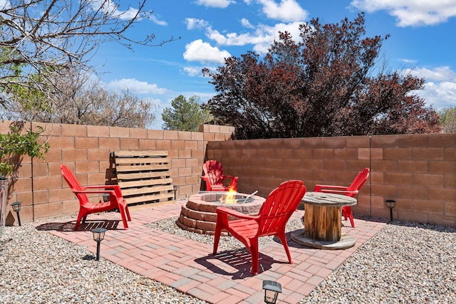 10532 Box Canyon Pl NW, Albuquerque, NM 87114 - view of patio featuring an outdoor fire pit and fence
