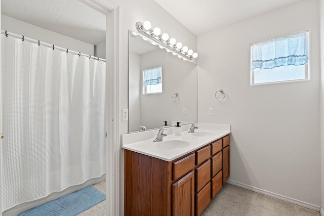 10532 Box Canyon Pl NW, Albuquerque, NM 87114 - bathroom featuring double vanity and baseboards