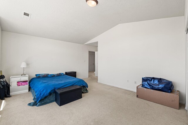 10532 Box Canyon Pl NW, Albuquerque, NM 87114 - carpeted bedroom with vaulted ceiling, a textured ceiling, and baseboards