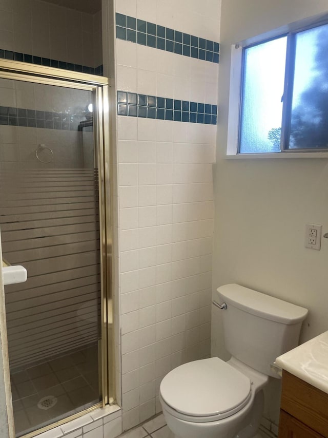 bathroom with vanity, tile patterned floors, a shower stall, and toilet