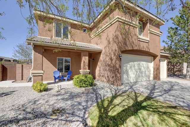 1807 Avenida Comunidad, Rio Rancho, NM 87124 - view of front facade featuring stucco siding, an attached garage, a tile roof, and concrete driveway