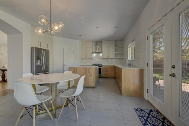 1807 Avenida Comunidad, Rio Rancho, NM 87124 - kitchen featuring wall chimney exhaust hood, stainless steel appliances, a kitchen island, open shelves, and backsplash