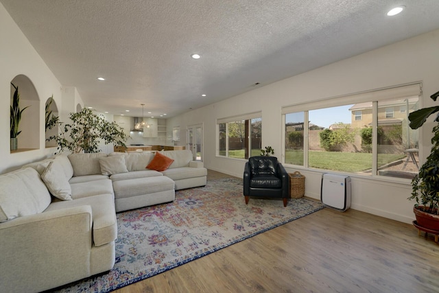 1807 Avenida Comunidad, Rio Rancho, NM 87124 - living room with a textured ceiling, wood finished floors, recessed lighting, and arched walkways