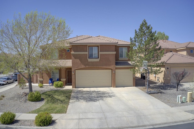 1807 Avenida Comunidad, Rio Rancho, NM 87124 - mediterranean / spanish house featuring an attached garage, stucco siding, driveway, and a tiled roof