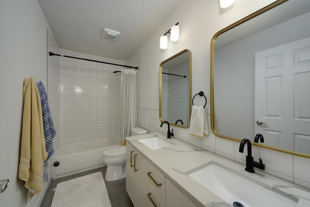 1807 Avenida Comunidad, Rio Rancho, NM 87124 - bathroom featuring double vanity, shower / tub combo, toilet, a textured ceiling, and tile patterned floors