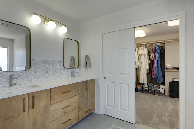 1807 Avenida Comunidad, Rio Rancho, NM 87124 - full bath with double vanity, tasteful backsplash, tile patterned flooring, and a walk in closet