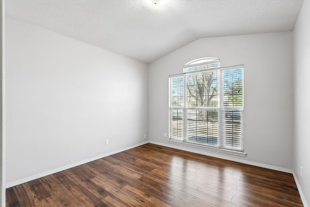 9712 Monteria Ct NW, Albuquerque, NM 87114 - empty room with dark wood-style floors, lofted ceiling, and a textured ceiling