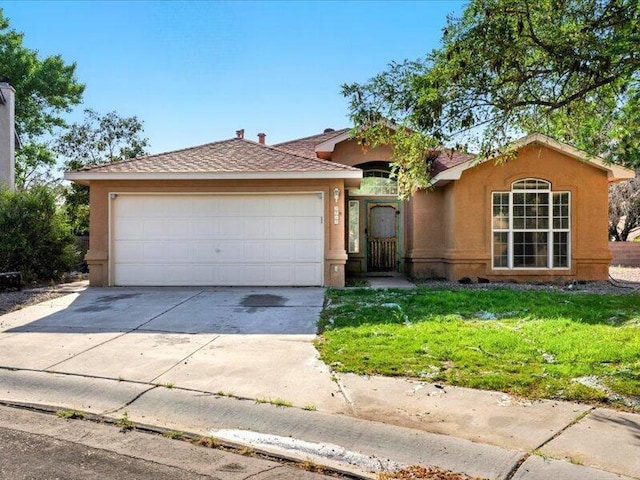 9712 Monteria Ct NW, Albuquerque, NM 87114 - ranch-style home with concrete driveway, an attached garage, a front yard, and stucco siding