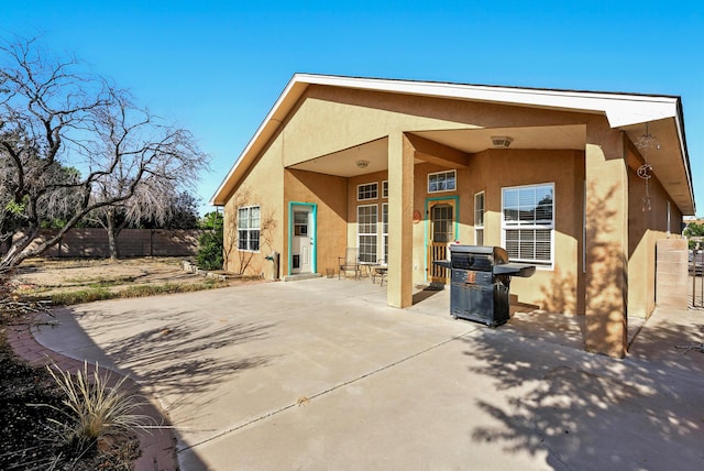 9712 Monteria Ct NW, Albuquerque, NM 87114 - rear view of house featuring stucco siding and a patio