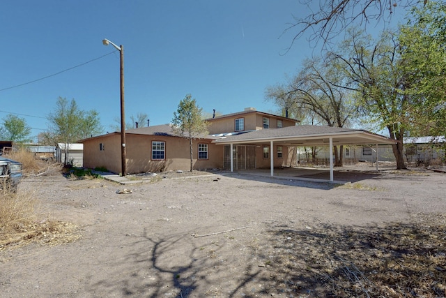 1647 Atrisco Dr SW, Albuquerque, NM 87105 - rear view of property featuring a carport and stucco siding