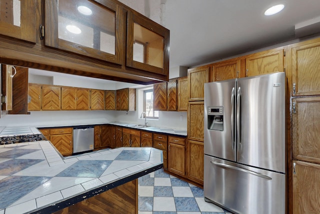 1647 Atrisco Dr SW, Albuquerque, NM 87105 - kitchen featuring stainless steel appliances, a sink, tile counters, brown cabinets, and recessed lighting