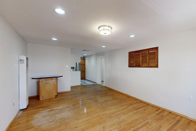 1647 Atrisco Dr SW, Albuquerque, NM 87105 - spare room with a heating unit, light wood-style floors, baseboards, and recessed lighting