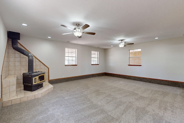 1647 Atrisco Dr SW, Albuquerque, NM 87105 - unfurnished living room with a wood stove, carpet, recessed lighting, a ceiling fan, and baseboards