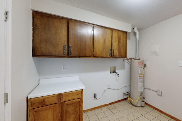 1647 Atrisco Dr SW, Albuquerque, NM 87105 - washroom featuring cabinet space, water heater, hookup for a washing machine, and baseboards