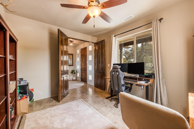 office space with a ceiling fan and visible vents