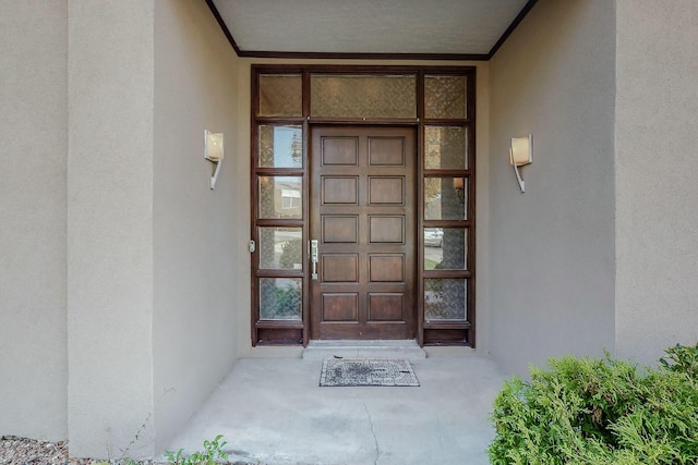 property entrance featuring stucco siding
