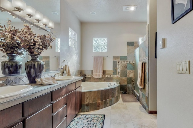 full bath with a garden tub, double vanity, a sink, and tile patterned flooring