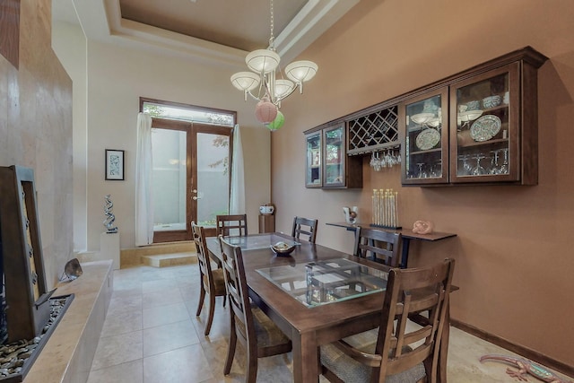 dining space featuring light tile patterned floors and baseboards