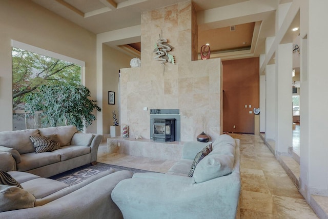 living area featuring a high ceiling and baseboards