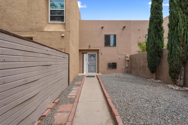 2700 Vista Grande Dr NW Unit 56, Albuquerque, NM 87120 - doorway to property with stucco siding and fence