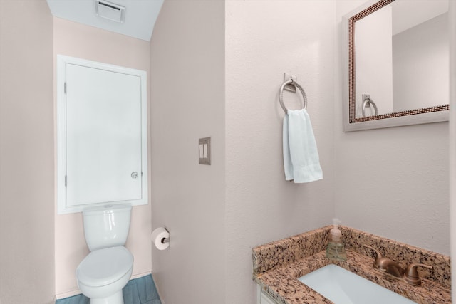 2700 Vista Grande Dr NW Unit 56, Albuquerque, NM 87120 - half bath with visible vents, toilet, vanity, and baseboards