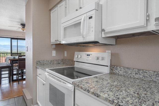 2700 Vista Grande Dr NW Unit 56, Albuquerque, NM 87120 - kitchen featuring ceiling fan, white cabinetry, white appliances, and a textured wall