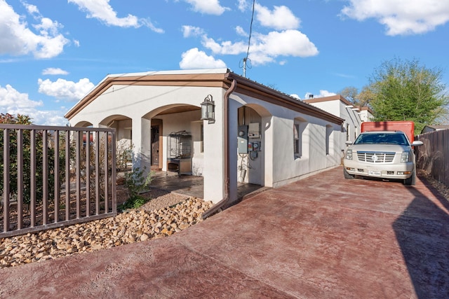 2912 William St SE, Albuquerque, NM 87102 - view of home's exterior featuring concrete driveway, fence, and stucco siding