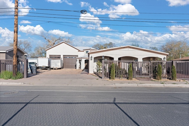 2912 William St SE, Albuquerque, NM 87102 - view of front of house featuring a garage, concrete driveway, and fence