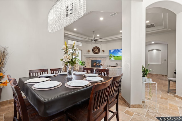 2912 William St SE, Albuquerque, NM 87102 - dining area featuring a ceiling fan, stone tile flooring, a tray ceiling, and visible vents