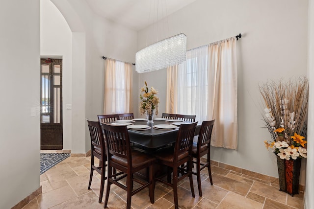 2912 William St SE, Albuquerque, NM 87102 - dining room with baseboards, stone tile flooring, and a notable chandelier