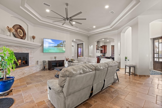 2912 William St SE, Albuquerque, NM 87102 - living area featuring visible vents, a tray ceiling, arched walkways, and stone tile floors