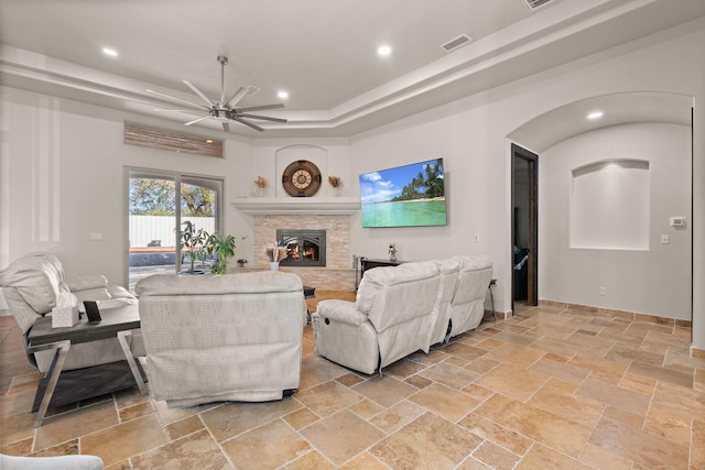 2912 William St SE, Albuquerque, NM 87102 - living area featuring a ceiling fan, a stone fireplace, stone tile floors, visible vents, and recessed lighting