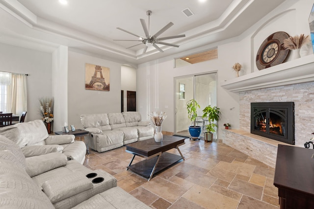 2912 William St SE, Albuquerque, NM 87102 - living room with ceiling fan, stone tile floors, visible vents, and a raised ceiling
