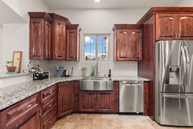 2912 William St SE, Albuquerque, NM 87102 - kitchen featuring light stone counters, a sink, stone tile flooring, appliances with stainless steel finishes, and recessed lighting