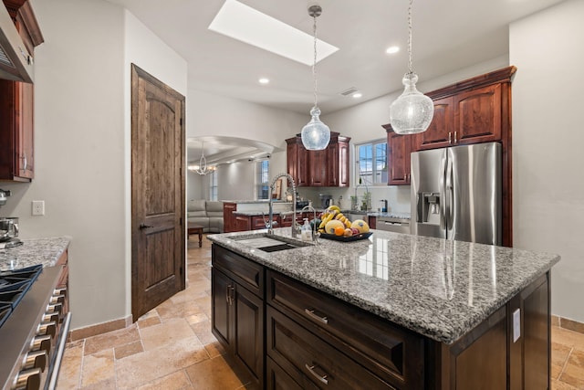 2912 William St SE, Albuquerque, NM 87102 - kitchen with a sink, stone tile floors, recessed lighting, a skylight, and stainless steel refrigerator with ice dispenser