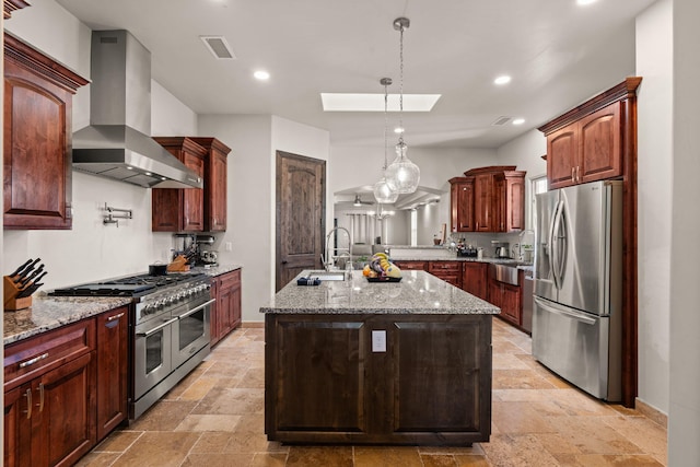 2912 William St SE, Albuquerque, NM 87102 - kitchen featuring stone tile floors, light stone counters, wall chimney range hood, a sink, and appliances with stainless steel finishes