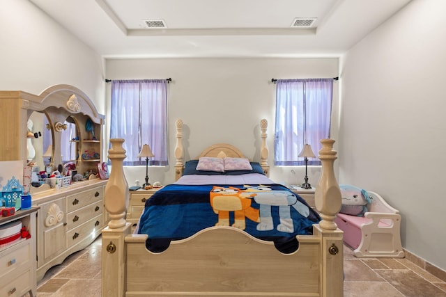 2912 William St SE, Albuquerque, NM 87102 - bedroom with stone finish flooring, visible vents, and a raised ceiling