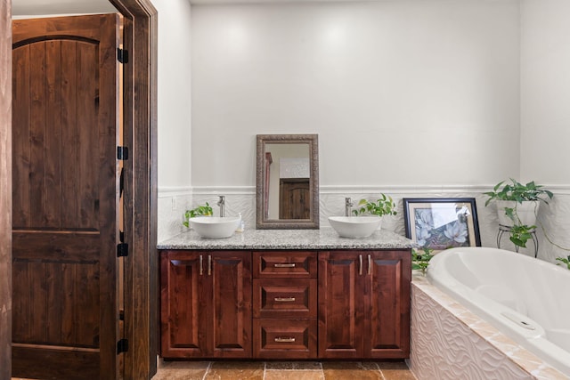 2912 William St SE, Albuquerque, NM 87102 - full bath with double vanity, wainscoting, tiled bath, and a sink