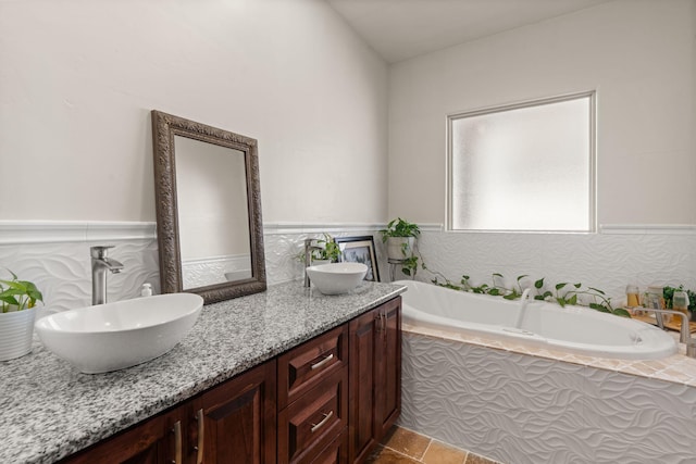 2912 William St SE, Albuquerque, NM 87102 - bathroom with wainscoting, a garden tub, a sink, and double vanity