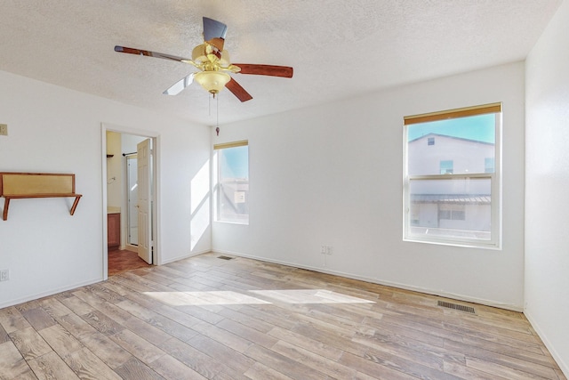 2740 Wilder Loop NE, Rio Rancho, NM 87144 - unfurnished room featuring visible vents, baseboards, ceiling fan, a textured ceiling, and wood finished floors