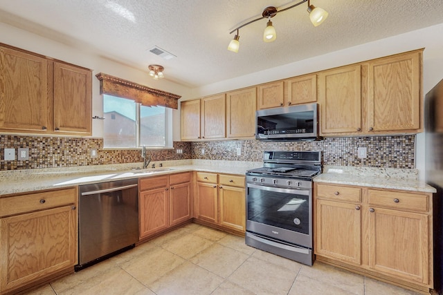 2740 Wilder Loop NE, Rio Rancho, NM 87144 - kitchen with a sink, visible vents, decorative backsplash, and stainless steel appliances