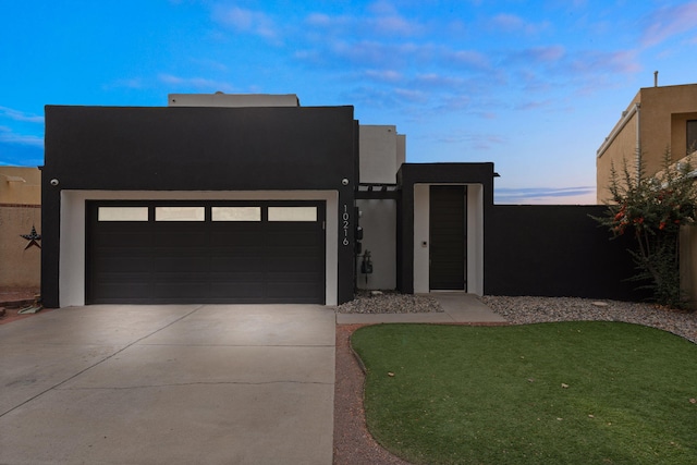 modern home featuring stucco siding, concrete driveway, and a garage